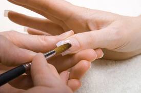 Gel nails are applied/sculpted with a brush for natural and precise results.